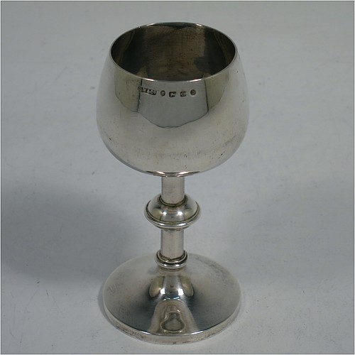 An Antique Victorian Sterling Silver three-piece travelling communion set consisting of chalice, paten, and wine bottle. The chalice having a plain round body with a middle baluster stem, and sitting on a pedestal foot. The paten having a plain round body with a flat border, and sitting on a pedestal foot. The wine bottle having a plain round screw-off corked lid, and the glass body with hand-cut panelled decoration. All three pieces sit in their original purple satin and velvet-lined presentation box. Made by Horace Woodward and Co., of Birmingham in 1882. The dimensions of this fine hand-made antique silver travelling communion set are height of chalice 9 cms (3.5 inches), diameter of paten 7 cms (2.75 inches), height of bottle 10 cms (4 inches), and with a total weight of approx. 93g (3 troy ounces). Please note that the interior material lining is stained, there is damage to the wooden box where the clasp is, and there is a contemporaneous inscription underneath the paten.