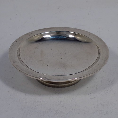 An Antique Victorian Sterling Silver three-piece travelling communion set consisting of chalice, paten, and wine bottle. The chalice having a plain round body with a middle baluster stem, and sitting on a pedestal foot. The paten having a plain round body with a flat border, and sitting on a pedestal foot. The wine bottle having a plain round screw-off corked lid, and the glass body with hand-cut panelled decoration. All three pieces sit in their original purple satin and velvet-lined presentation box. Made by Horace Woodward and Co., of Birmingham in 1882. The dimensions of this fine hand-made antique silver travelling communion set are height of chalice 9 cms (3.5 inches), diameter of paten 7 cms (2.75 inches), height of bottle 10 cms (4 inches), and with a total weight of approx. 93g (3 troy ounces). Please note that the interior material lining is stained, there is damage to the wooden box where the clasp is, and there is a contemporaneous inscription underneath the paten.