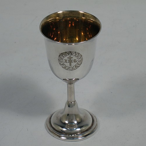 An Antique Victorian silver-plated three-piece travelling communion set consisting of a chalice, paten, and wine bottle. The chalice having a plain round body, a gold-gilt interior, and sitting on a pedestal foot. The paten having a round body with a reeded border, and sitting on a collet foot. The wine bottle having a plain round screw-off lid, an original glass stopper, and the glass body with hand-cut panelled decoration. The chalice and paten are engraved with a Christogram, and all sit in their original blue velvet-lined presentation box. Made in ca. 1890. The dimensions of this fine hand-made antique silver plated travelling communion set are height of chalice 7.5 cms (3 inches), diameter of paten 8 cms (3 inches), and height of wine bottle 8.5 cms (3.3 inches).