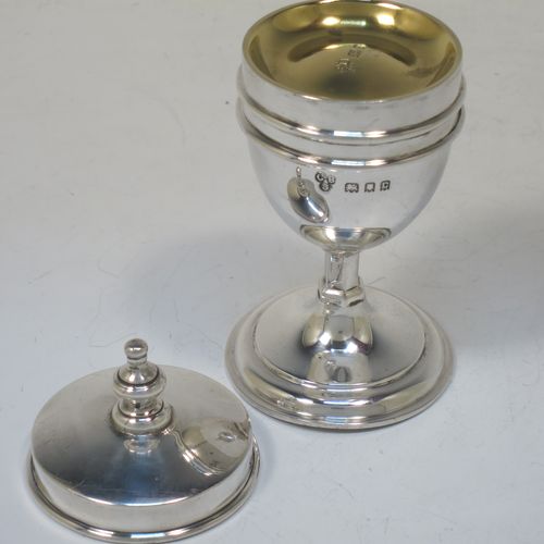 A handsome and unusual Antique Sterling Silver two-piece travelling communion set consisting of a chalice body for consecrated wine, together with lift-off pyx box with cover lid for host wafers. The lid with an applied urn-shaped finial, and the pyx body having a gold-gilt interior. Made by Charles Boyton and Sons of London in 1918. The dimensions of this fine hand-made antique silver travelling communion set are height 10 cms (4 inches), diameter of main body 4.5 cms (1.75 inches), and it weighs approx. 92g (3 troy ounces).  