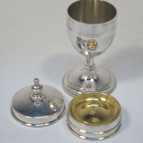 A handsome and unusual Antique Sterling Silver two-piece travelling communion set consisting of a chalice body for consecrated wine, together with lift-off pyx box with cover lid for host wafers. The lid with an applied urn-shaped finial, and the pyx body having a gold-gilt interior. Made by Charles Boyton and Sons of London in 1918. The dimensions of this fine hand-made antique silver travelling communion set are height 10 cms (4 inches), diameter of main body 4.5 cms (1.75 inches), and it weighs approx. 92g (3 troy ounces).  