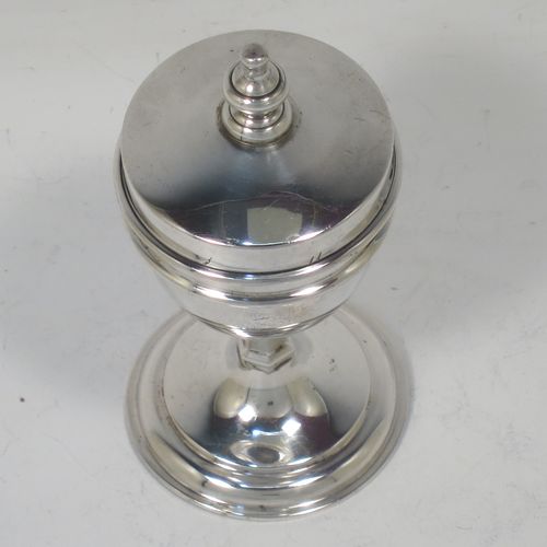 A handsome and unusual Antique Sterling Silver two-piece travelling communion set consisting of a chalice body for consecrated wine, together with lift-off pyx box with cover lid for host wafers. The lid with an applied urn-shaped finial, and the pyx body having a gold-gilt interior. Made by Charles Boyton and Sons of London in 1918. The dimensions of this fine hand-made antique silver travelling communion set are height 10 cms (4 inches), diameter of main body 4.5 cms (1.75 inches), and it weighs approx. 92g (3 troy ounces).  