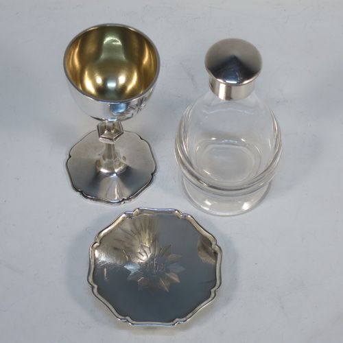A handsome Antique Victorian Sterling Silver three-piece travelling communion set consisting of a chalice with gold-gilt interior, a paten with an applied shaped border, and a wine bottle with screw-off lid. The chalice and paten made by George Richards and Edward Brown of London in 1865, and the wine bottle by H. F. and Co. Ltd., of London in 1965. The dimensions of this fine antique silver travelling communion set are height of chalice 9 cms (3.5 inches), diameter of paten 7 cms (2.75 inches), height of wine bottle 10 cms (4 inches), with a total  weight of approx. 126g (4 troy ounces). Please note that the chalice and paten have hand engraved christograms. 
