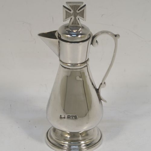 A very elegant Antique Edwardian Sterling Silver three-piece travelling communion set consisting of chalice, paten, and wine ewer. The chalice having a plain round bellied body, a gold-gilt interior, and sitting on a pedestal foot. The paten having a round body with an applied Chippendale border, and sitting on a pedestal foot. The wine ewer having a plain bellied body, a pull-off top with cork stopper and cruciform finial, a scroll side-handle, and sitting on a pedestal foot. All three pieces are hand-engraved with an IHS Christogram, and they are all sitting in their original dark blue satin and velvet-lined presentation box. This beautiful communion service was made by Charles Cook of Chester in 1905. The dimensions of this fine hand-made antique silver travelling communion set are height of chalice 8.5 cms (3.3 inches), diameter of paten 7 cms (2.75 inches), height of wine ewer 11 cms (4.25 inches), and with a total weight of approx. 160g (5.2 troy ounces). Please note that the paten has a contemporaneous presentation inscription underneath-to be removed.