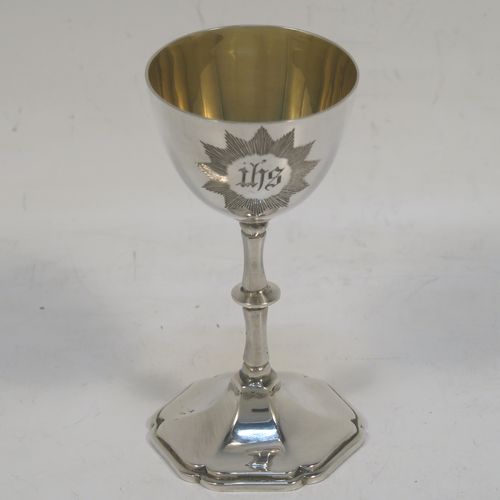 A very elegant Antique Edwardian Sterling Silver three-piece travelling communion set consisting of chalice, paten, and wine ewer. The chalice having a plain round bellied body, a gold-gilt interior, and sitting on a pedestal foot. The paten having a round body with an applied Chippendale border, and sitting on a pedestal foot. The wine ewer having a plain bellied body, a pull-off top with cork stopper and cruciform finial, a scroll side-handle, and sitting on a pedestal foot. All three pieces are hand-engraved with an IHS Christogram, and they are all sitting in their original dark blue satin and velvet-lined presentation box. This beautiful communion service was made by Charles Cook of Chester in 1905. The dimensions of this fine hand-made antique silver travelling communion set are height of chalice 8.5 cms (3.3 inches), diameter of paten 7 cms (2.75 inches), height of wine ewer 11 cms (4.25 inches), and with a total weight of approx. 160g (5.2 troy ounces). Please note that the paten has a contemporaneous presentation inscription underneath-to be removed.