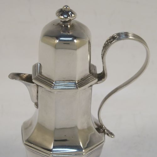 A very elegant and unusual Antique Sterling Silver small travelling communion wine flagon or ewer, having a plain octagonal panelled body, with a reeded scroll handle, a sparrow-beak spout, a screw-in matching lid with cast finial, and all sitting on a pedestal foot. This handsome silver travelling communion wine ewer or flagon was made by Charles Boyton and Sons of Sheffield in 1913. The dimensions of this fine hand-made antique silver travelling communion wine ewer are height 11 cms (4.25 inches), length 7 cms (2.75 inches), and it weighs approx. 119g (3.8 troy ounces).