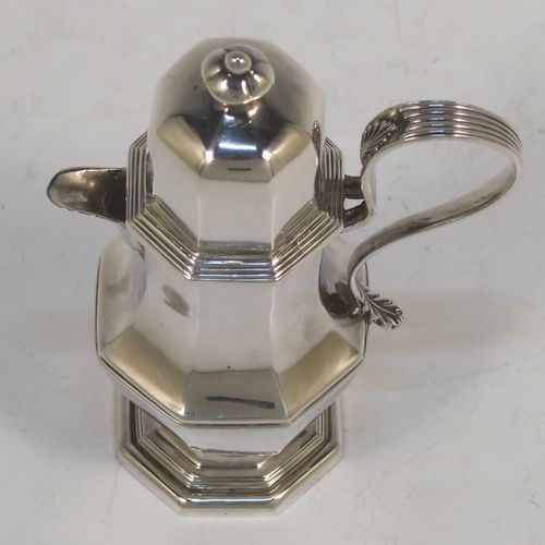 A very elegant and unusual Antique Sterling Silver small travelling communion wine flagon or ewer, having a plain octagonal panelled body, with a reeded scroll handle, a sparrow-beak spout, a screw-in matching lid with cast finial, and all sitting on a pedestal foot. This handsome silver travelling communion wine ewer or flagon was made by Charles Boyton and Sons of Sheffield in 1913. The dimensions of this fine hand-made antique silver travelling communion wine ewer are height 11 cms (4.25 inches), length 7 cms (2.75 inches), and it weighs approx. 119g (3.8 troy ounces).