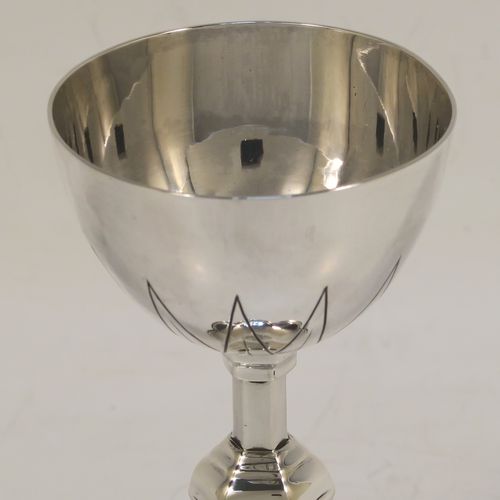 A handsome Antique Sterling Silver small travelling communion chalice, having a plain round tapering cup, a middle hexagonal baluster, and sitting on a hexafoil pedestal foot. This beautiful antique silver chalice was made in London in 1919. The dimensions of this fine hand-made silver chalice are height 10 cms (4 inches), diameter of cup 5 cms (2 inches), and a weight of approx. 78g (2.5 troy ounces).   