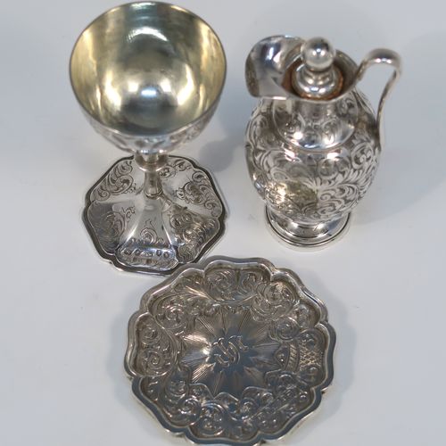 A beautiful Antique Victorian Sterling Silver three-piece travelling communion set consisting of chalice, paten, and wine flagon. In a round bellied style, having the remains of a gold-gilt interior to the chalice, an amphora style flagon, and a paten with an applied border and pedestal foot, all over hand-engraved with floral and scroll decoration. This very pretty silver communion set was made by Yapp and Woodward of Birmingham in 1849. The dimensions of this fine hand-made antique silver travelling communion set are height of flagon 9 cms (3.5 inches), diameter of paten 6.5 cms (2.5 inches), and with a total weight of approx. 129g (4 troy ounces). Please note that all items are engraved with a Christogram, and the paten and chalice are engraved with contemporaneous sets of initials.   