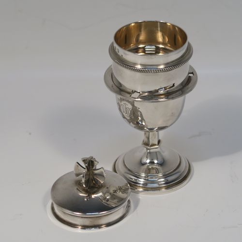 A handsome and unusual Sterling Silver two-piece travelling communion set consisting of a chalice body for consecrated wine, together with a bayonet fit lift-off pyx box with cover lid for host wafers. The lid with an applied cross-shaped finial, and the chalice and pyx body having gold-gilt interiors, all in its original purple velvet and satin-lined carrying case. This elegant silver communion set was made by Mowbray and Co., of London in 1939. The dimensions of this fine hand-made silver travelling communion set are height 11 cms (4.25 inches), diameter of main body 5 cms (2 inches), and it weighs approx. 154g (5 troy ounces). Please note that the main body is engraved with a Christogram.