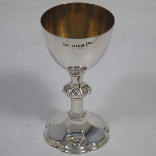 An Antique Victorian Sterling Silver three-piece travelling communion set consisting of a chalice, paten, and wine bottle. The chalice having a plain round cup with a gold-gilt interior, a hand-chased middle baluster stem, and sitting on a spreading hexafoil pedestal foot. The paten having a plain round body with a hexafoil shaped interior and applied reeded border. The wine bottle having a plain round screw-off corked lid, and the glass body with tapering sides and flat base. All three pieces sit in their original dark blue velvet-lined presentation box. Made by Walker and Hall of Sheffield in 1892. The dimensions of this fine hand-made antique silver travelling communion set are height of chalice 10 cms (4 inches), diameter of paten 8.5 cms (3.3 inches), height of bottle 8 cms (3 inches), and with a total weight of approx. 125g (4 troy ounces).   