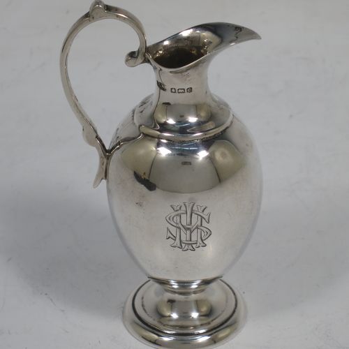 A handsome Antique Edwardian Sterling Silver three-piece travelling communion set consisting of chalice, paten, and wine flagon. In a plain round style, having a gold-gilt interior to the chalice,  an amphora style flagon, and a paten with an applied border and pedestal foot. All the pieces sit in their original cream satin and blue velvet-lined presentation box. Made by Thomas Wooley of Birmingham in 1902. The dimensions of this fine hand-made antique silver travelling communion set are height of flagon 9.5 cms (3.75 inches), diameter of paten 6 cms (2.5 inches), and with a total weight of approx. 113g (3.6 troy ounces). Please note that all items are engraved with a Christogram, and that the flagon does not have a stopper.   