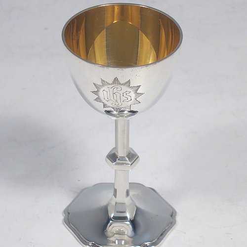 A Sterling Silver four-piece travelling communion set consisting of chalice, paten, spoon, and wine bottle. The chalice having a plain round body, a gold-gilt interior, and sitting on a hexagonal pedestal foot. The paten having a hexagonal body with an applied shaped border, and sitting on a collet foot. The wine bottle having a plain round screw-off lid, a cork seal, and the glass body with hand-cut panelled decoration. The anointing spoon having a plain oval bowl and ball finial. Both the chalice and paten are engraved with a Christogram. All sitting in its original purple satin and velvet-lined presentation box. Made by A. R. Mowbray & Co. Ltd., of London in 1930. The dimensions of this fine hand-made silver travelling communion set are height of chalice 8 cms (3.25 inches), diameter of paten 5.5 cms (2.25 inches), length of spoon 10 cms (4 inches), and with a total weight of approx. 125g (4 troy ounces).    