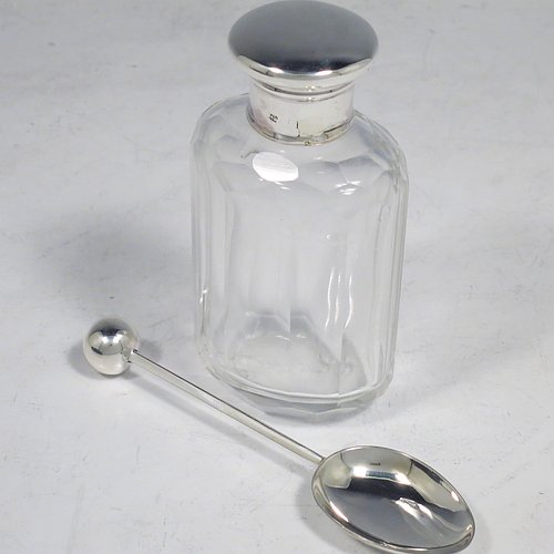 A Sterling Silver four-piece travelling communion set consisting of chalice, paten, spoon, and wine bottle. The chalice having a plain round body, a gold-gilt interior, and sitting on a hexagonal pedestal foot. The paten having a hexagonal body with an applied shaped border, and sitting on a collet foot. The wine bottle having a plain round screw-off lid, a cork seal, and the glass body with hand-cut panelled decoration. The anointing spoon having a plain oval bowl and ball finial. Both the chalice and paten are engraved with a Christogram. All sitting in its original purple satin and velvet-lined presentation box. Made by A. R. Mowbray & Co. Ltd., of London in 1930. The dimensions of this fine hand-made silver travelling communion set are height of chalice 8 cms (3.25 inches), diameter of paten 5.5 cms (2.25 inches), length of spoon 10 cms (4 inches), and with a total weight of approx. 125g (4 troy ounces).    