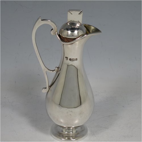 An Antique Sterling Silver four-piece travelling communion set consisting of chalice, paten, wine flagon, and pyx box. In a very plain round style, having a gold-gilt interior to the chalice, a pull-off lid with cork on the flagon, and a pull-off lid for the pyx box. All the pieces sit in their original blue velvet-lined presentation box which has an applied inscription attached to the top of the lid. Made by Martin Hall & Co., of Sheffield in 1912. The dimensions of this fine hand-made antique silver travelling communion set are height of flagon 13 cms (5 inches), diameter of paten 9 cms (3.5 inches), and with a total weight of approx. 254g (8.2 troy ounces).   