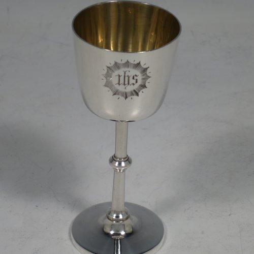 An Antique Victorian Sterling Silver three-piece travelling communion set consisting of chalice, paten, and wine ewer (with pull-off lid and cork seal), having plain round baluster bodies, the chalice with a gold-gilt interior, all having engraved christograms and in their original leather upright presentation box with dark blue velvet and satin-lined interior. Made by Martin & Hall of Sheffield between 1888 to 1890. The dimensions of this fine hand-made antique silver travelling communion set are height of ewer 11 cms (4.25 inches), diameter of paten 8 cms (3.25 inches), and with a total weight of approx. 155g (5 troy ounces).