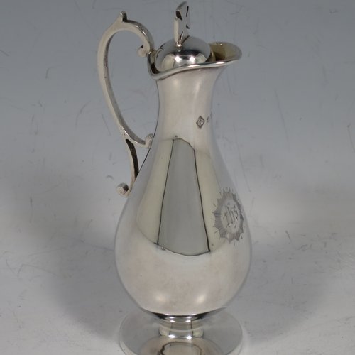 An Antique Victorian Sterling Silver three-piece travelling communion set consisting of chalice, paten, and wine ewer (with pull-off lid and cork seal), having plain round baluster bodies, the chalice with a gold-gilt interior, all having engraved christograms and in their original leather upright presentation box with dark blue velvet and satin-lined interior. Made by Martin & Hall of Sheffield between 1888 to 1890. The dimensions of this fine hand-made antique silver travelling communion set are height of ewer 11 cms (4.25 inches), diameter of paten 8 cms (3.25 inches), and with a total weight of approx. 155g (5 troy ounces).