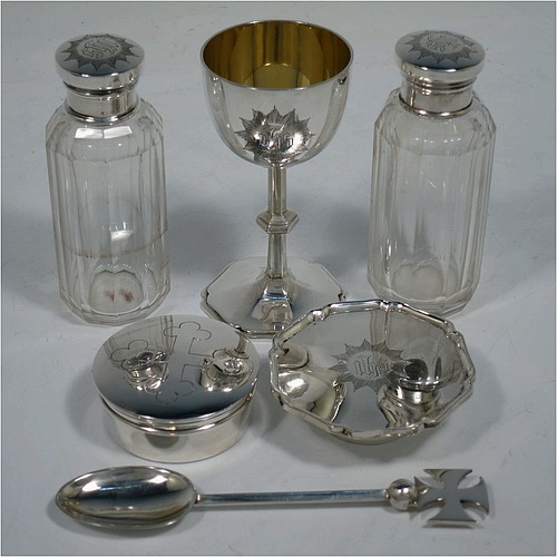 A complete Antique Sterling Silver six-piece travelling communion set consisting of chalice, paten, water, and wine bottles, a wafer pyx box, and an anointing spoon. The chalice having a plain round body with gold-gilt interior, and sitting on a round pedestal foot. The paten and pyx box having plain round bodies. The wine and water bottles having plain round screw-off lids, cork seals, and hand-cut crystal bodies. All hand-engraved with Christograms and sitting in their original purple satin and velvet-lined presentation box. All made by Frederick Dendy Wray of London in 1913. The dimensions of this fine hand-made antique silver travelling communion set are height of chalice 8.5 cms (3.3 inches), diameter of paten 5.5 cms (2.25 inches), and with a total weight of approx. 125g (4 troy ounces). Please note that the box lid exterior is monogrammed with a set of contemporaneous initials.