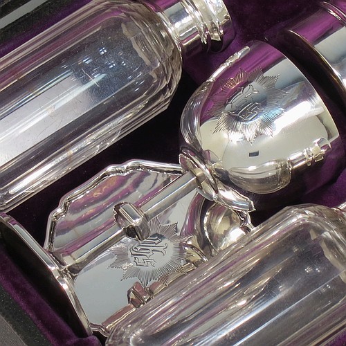 A complete Antique Sterling Silver six-piece travelling communion set consisting of chalice, paten, water, and wine bottles, a wafer pyx box, and an anointing spoon. The chalice having a plain round body with gold-gilt interior, and sitting on a round pedestal foot. The paten and pyx box having plain round bodies. The wine and water bottles having plain round screw-off lids, cork seals, and hand-cut crystal bodies. All hand-engraved with Christograms and sitting in their original purple satin and velvet-lined presentation box. All made by Frederick Dendy Wray of London in 1913. The dimensions of this fine hand-made antique silver travelling communion set are height of chalice 8.5 cms (3.3 inches), diameter of paten 5.5 cms (2.25 inches), and with a total weight of approx. 125g (4 troy ounces). Please note that the box lid exterior is monogrammed with a set of contemporaneous initials.
