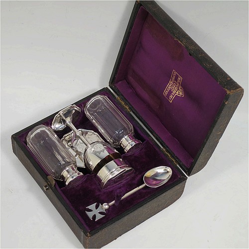 A complete Antique Sterling Silver six-piece travelling communion set consisting of chalice, paten, water, and wine bottles, a wafer pyx box, and an anointing spoon. The chalice having a plain round body with gold-gilt interior, and sitting on a round pedestal foot. The paten and pyx box having plain round bodies. The wine and water bottles having plain round screw-off lids, cork seals, and hand-cut crystal bodies. All hand-engraved with Christograms and sitting in their original purple satin and velvet-lined presentation box. All made by Frederick Dendy Wray of London in 1913. The dimensions of this fine hand-made antique silver travelling communion set are height of chalice 8.5 cms (3.3 inches), diameter of paten 5.5 cms (2.25 inches), and with a total weight of approx. 125g (4 troy ounces). Please note that the box lid exterior is monogrammed with a set of contemporaneous initials.