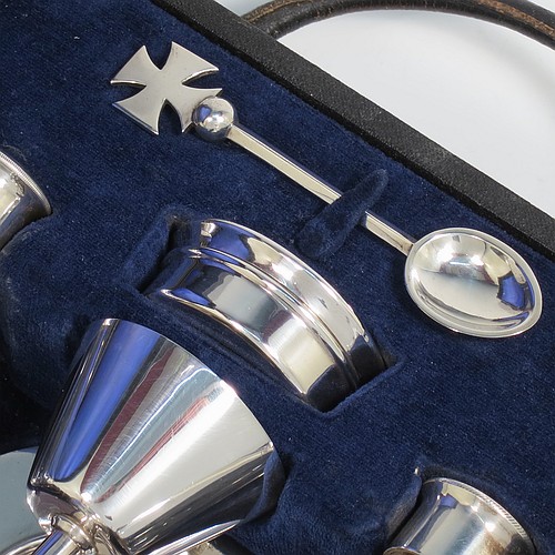 A Sterling Silver six-piece travelling communion set consisting of chalice, paten, water, and wine bottles, a wafer pyx box, and an anointing spoon. The chalice having a plain round body with tapering sides, and sitting on a round pedestal foot. The paten and pyx box having plain round bodies. The wine and water bottles having plain round screw-off lids, cork seals, and hand-cut crystal bodies. All sitting in their original dark blue satin and velvet-lined presentation box, which also has a concealed compartment for sacramental cloth and wafers. All made by H. F. and Co. Ltd., of London in 1966. The dimensions of this fine hand-made silver travelling communion set are height of chalice 8.5 cms (3.3 inches), diameter of paten 8.5 cms (3.3 inches), and with a total weight of approx. 155g (5 troy ounces). Please note that there is slight damage to the box interior, but every item is still held securely.