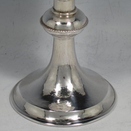 A Sterling Silver small communion chalice, having a plain round body, with a hand-hammered or finish, a central baluster with an applied rope-twist border, and sitting on a pedestal foot. Made by Greenwood & Watts of London in 1926. The dimensions of this fin hand-made silver communion cup are height 11.5 cms (4.5 inches), diameter of base 7 cms (2.75 inches), and it weighs approx. 107g (3.4 troy ounces).