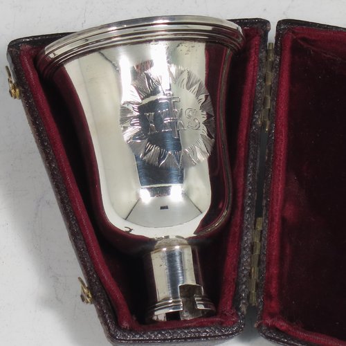 A rare Antique Georgian (William IV) Sterling Silver collapsible travelling communion set, consisting of a chalice, paten, and bottle, with a bayonet-fit mechanism. The chalice having a round body with reeded borders, and a gold-gilt interior. The bottle having the same style, but slightly smaller to fit inside the goblet when collapsed, and a pull-off stopper. The paten having a round body with a reeded border, and sitting on a collet foot. All three are engraved with a Christogram, and all sit in their original maroon velvet-lined and leather presentation box. Made by Charles Rawlings & William Summer of London in 1836. The dimensions of this fine hand-made silver travelling communion set are height (when attached together) 11 cms (4.25 inches), diameter of paten 5 cms (2 inches), and with a total weight of approx. 125g (4 troy ounces).