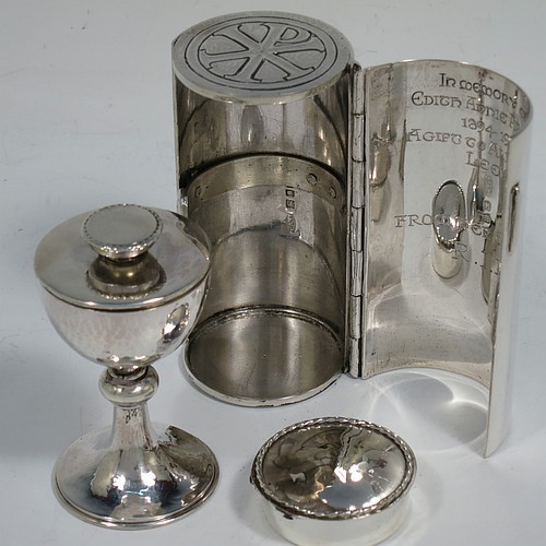 A lovely Arts and Crafts style Sterling Silver travelling communion set with hand-hammered decoration, consisting of a chalice with pull-off lid and gold-gilt interior, the lid also acting as a paten, a pyx box with hinged lid and gold-gilt interior, all fitted into an original silver cannister style hinged holder with a push-button latch and an applied Christogram on top. Made by Greenwood and Watts of London in 1927. The dimensions of this fine hand-made silver travelling communion set are length of cannister 8.5 cms (3.25 inches), height of chalice with lid 6.5 cms (2.5 inches), diameter of pyx box 3.5 cms (1.3 inches), with a total weight of approx. 212g (6.8 troy ounces). Please note that this item has an In Memorium inscription engraved on the inside of the cannister.