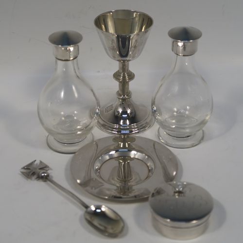 A large and complete Antique Sterling Silver six-piece travelling communion set consisting of chalice, paten, water, and wine bottles, a wafer pyx box, and an anointing spoon. The chalice having a plain round body with tapering sides, a gold-gilt interior, and sitting on a round pedestal foot. The paten and pyx box having plain round bodies. The wine and water bottles having plain round screw-off lids, cork seals, and hand-cut crystal bodies. All sitting in their original dark blue satin and velvet-lined presentation box with secure catches and carrying handles. All made by Blut and Wray of London in 1915. The dimensions of this fine hand-made antique silver travelling communion set are height of chalice 9 cms (3.5 inches), diameter of paten 8 cms (3.25 inches), and with a total weight of approx. 150g (4.8 troy ounces).