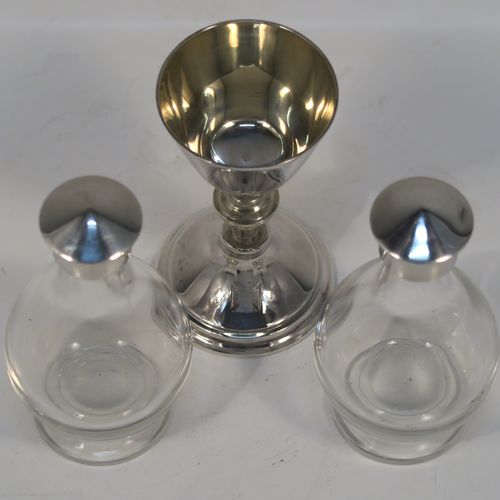 A large and complete Antique Sterling Silver six-piece travelling communion set consisting of chalice, paten, water, and wine bottles, a wafer pyx box, and an anointing spoon. The chalice having a plain round body with tapering sides, a gold-gilt interior, and sitting on a round pedestal foot. The paten and pyx box having plain round bodies. The wine and water bottles having plain round screw-off lids, cork seals, and hand-cut crystal bodies. All sitting in their original dark blue satin and velvet-lined presentation box with secure catches and carrying handles. All made by Blut and Wray of London in 1915. The dimensions of this fine hand-made antique silver travelling communion set are height of chalice 9 cms (3.5 inches), diameter of paten 8 cms (3.25 inches), and with a total weight of approx. 150g (4.8 troy ounces).
