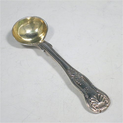 An Antique Georgian Sterling Silver pair of salt spoons, in the double-struck Kings pattern, having gold-gilt bowls. All made by William Traies of London in 1827. The dimensions of these fine hand-made antique silver salt spoons are length 11 cms (4.25 inches), and they weigh a total of approx. 90g (3 troy ounces). Please note that these salt spoons are crested.