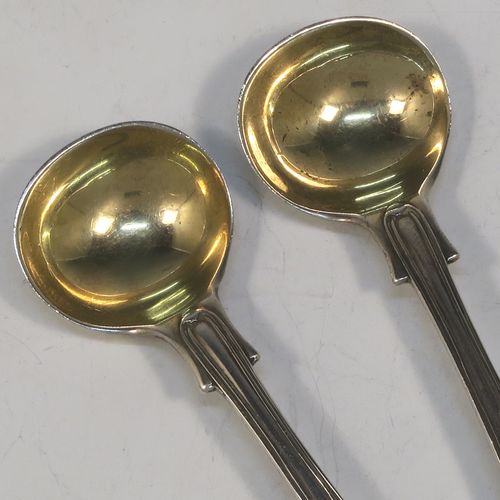 A very elegant and quite large Antique Edwardian Sterling Silver pair of salt spoons, in the double-struck Kings pattern, having gold-gilt bowls. All made by Jackson and Fullerton of London in 1906. The dimensions of these fine hand-made antique silver salt spoons are length 11.5 cms (4.5 inches), and they weigh a total of approx. 42g (1.4 troy ounces).