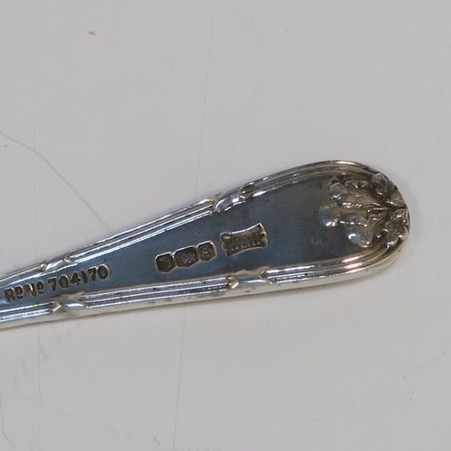 A very pretty pair of Sterling Silver salt spoons, in a double-struck Ribbon and Reed and Oak-Leaf pattern. These beautiful silver condiment spoons were made by Walker and Hall of Sheffield in 1933. The dimensions of these fine hand-made silver spoons are length 8.5 cms (3.3 inches), and they weigh a total of approx. 21g (0.7 troy ounces). Please note that they have a design registration number engraved on the back.