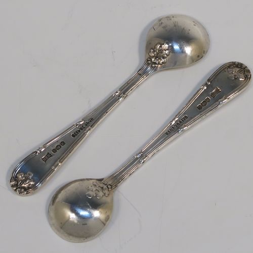 A very pretty pair of Sterling Silver salt spoons, in a double-struck Ribbon and Reed and Oak-Leaf pattern. These beautiful silver condiment spoons were made by Walker and Hall of Sheffield in 1933. The dimensions of these fine hand-made silver spoons are length 8.5 cms (3.3 inches), and they weigh a total of approx. 21g (0.7 troy ounces). Please note that they have a design registration number engraved on the back.