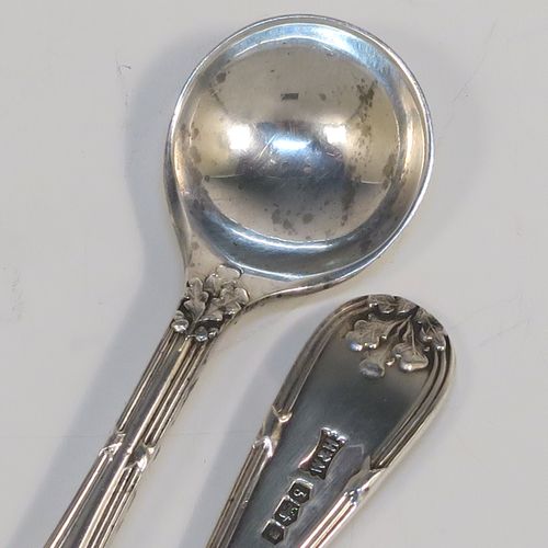 A very pretty pair of Sterling Silver salt spoons, in a double-struck Ribbon and Reed and Oak-Leaf pattern. These beautiful silver condiment spoons were made by Walker and Hall of Sheffield in 1933. The dimensions of these fine hand-made silver spoons are length 8.5 cms (3.3 inches), and they weigh a total of approx. 21g (0.7 troy ounces). Please note that they have a design registration number engraved on the back.
