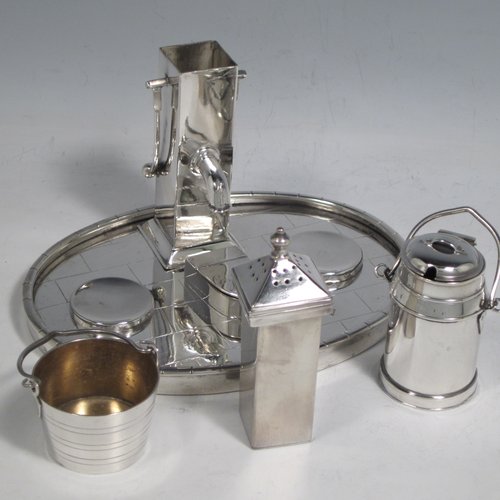 Antique Victorian silver plated condiment set, having a very unusual and rare design, showing the pepper pot as a water pump stand, the mustard pot as a milk churn, the salt cellar as a water pail, and a separate box with lid marked for cayenne. All sitting on an oval base made to look like a tiled kitchen floor. With a Diamond Registration mark for 28th May 1882. The dimensions of this fine hand-made silver-plated condiment set are length 15 cms (6 inches), height 11 cms (4.3 inches), and width 12 cms (4.75 inches).