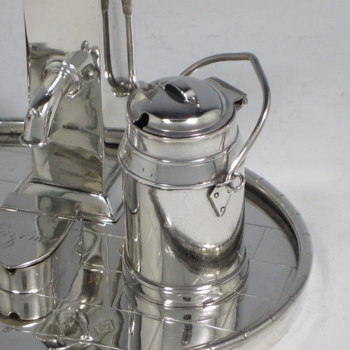 Antique Victorian silver plated condiment set, having a very unusual and rare design, showing the pepper pot as a water pump stand, the mustard pot as a milk churn, the salt cellar as a water pail, and a separate box with lid marked for cayenne. All sitting on an oval base made to look like a tiled kitchen floor. With a Diamond Registration mark for 28th May 1882. The dimensions of this fine hand-made silver-plated condiment set are length 15 cms (6 inches), height 11 cms (4.3 inches), and width 12 cms (4.75 inches).