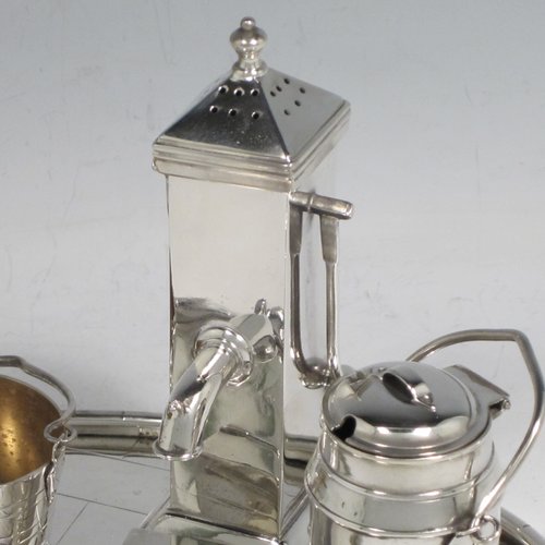 Antique Victorian silver plated condiment set, having a very unusual and rare design, showing the pepper pot as a water pump stand, the mustard pot as a milk churn, the salt cellar as a water pail, and a separate box with lid marked for cayenne. All sitting on an oval base made to look like a tiled kitchen floor. With a Diamond Registration mark for 28th May 1882. The dimensions of this fine hand-made silver-plated condiment set are length 15 cms (6 inches), height 11 cms (4.3 inches), and width 12 cms (4.75 inches).