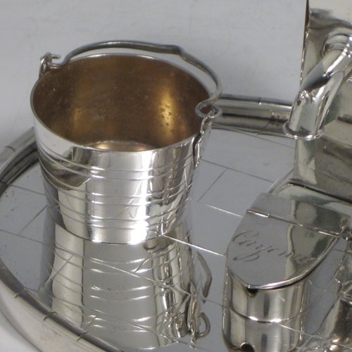 Antique Victorian silver plated condiment set, having a very unusual and rare design, showing the pepper pot as a water pump stand, the mustard pot as a milk churn, the salt cellar as a water pail, and a separate box with lid marked for cayenne. All sitting on an oval base made to look like a tiled kitchen floor. With a Diamond Registration mark for 28th May 1882. The dimensions of this fine hand-made silver-plated condiment set are length 15 cms (6 inches), height 11 cms (4.3 inches), and width 12 cms (4.75 inches).