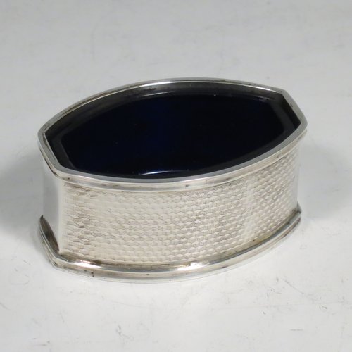 A Sterling Silver Art Deco condiment service, having oval straight-sided bodies with engine-turned decoration, with original blue-glass liners, pull-off lids on the peppers, hinged lids on the mustards, and all in original velvet and satin-lined presentation box. Consisting of two mustard pots, two pepper pots, two salt cellars, and four condiment spoons. Made in Chester and Birmingham from 1930 to 1934. Height of peppers 6.5 cms (2.5 inches), length of mustard 8 cms (3 inches), and a total weight of approx. 248g (8 troy ounces).
