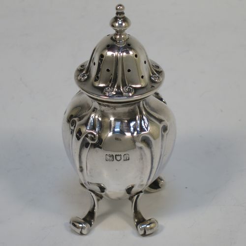 A handsome and large Antique Edwardian Sterling Silver seven-piece condiment service, consisting of a mustard pot with hinged lid and blue-glass liner, four salt cellars with blue-glass liners, and two pepper pots with pull-off lids, all with scroll fluted bellied bodies and sitting four scroll feet, and all fitted into their original dark blue satin and velvet-lined red presentation box. Made by James Round of London in 1903. The dimensions of this fine hand-made condiment service are height of pepper pot 9 cms (3.5 inches), length of mustard pot 9 cms (3.5 inches), and with a total weight of approx. 353g (11.4 troy ounces).