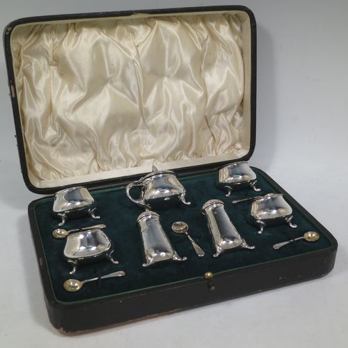A pretty Antique Edwardian Sterling Silver seven-piece condiment service, having plain round bellied bodies, with gold-gilt linings for the salt cellars, pull-off lids on the peppers, a hinged lid on the mustard pot and original blue-glass liner, together with five condiment spoons, and all in their original dark green velvet and cream satin-lined presentation box. Consisting of one mustard pot, two pepper pots, four salt cellars, and five condiment spoons. All made by Charles Edwards of London in 1904 (apart from the mustard spoon which is hallmarked for 1934). The dimensions of this fine hand-made silver condiment set are height of peppers 6 cms (2.3 inches), length of mustard 6 cms (2.3 inches), and with a total weight of approx. 235g (7.6 troy ounces).    