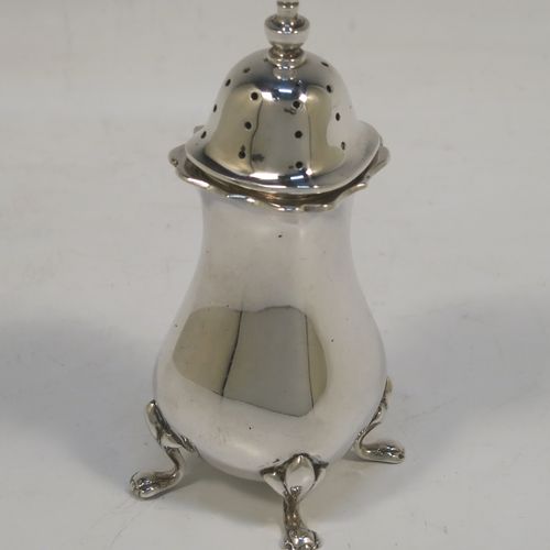 A handsome and large Antique Edwardian Silver Plated six-piece condiment service in a Chippendale style, consisting of two mustard pots with hinged lids and blue-glass liners, two salt cellars with blue-glass liners, two pepper pots with pull-off lids, all with bellied bodies and sitting on four scroll feet, together with two salt spoons and two mustard spoons, and all fitted into their original cream satin and and dark blue velvet-lined presentation box. This beautiful antique silver-plated condiment service was made by Walker and Hall of Sheffield in ca. 1910. The dimensions of this fine hand-made antique condiment service are height of pepper pots 10 cms (4 inches), length of mustard pots 10 cms (4 inches), and length of salt cellars 7.5 cms (3 inches).