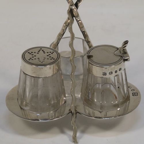 A very pretty and unusual Antique Victorian Sterling Silver Campfire style condiment set, consisting of a pepper shaker, mustard pot, and open salt with panelled cystal bodies and silver tops, all sitting in a campfire style frame with three tree branches joined together. This beautiful antique silver and crystal condiment set was made by Heath and Middleton of Birmingham in 1889. The dimensions of this fine hand-made antique silver condiment set are height 10 cms (4 inches), width 10 cms (4 inches), and it weighs approx. 70g (2.3 troy ounces).