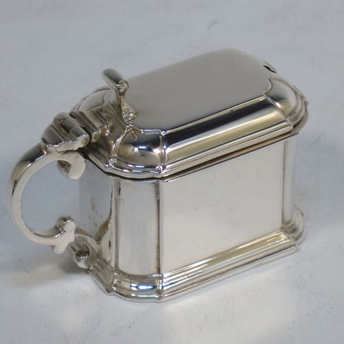 A very elegant Sterling Silver three-piece condiment set in an Art Deco style with straight-sided panelled bodies, consisting of an open salt cellar with a blue glass liner, a pepper pot with pull-off lid, a mustard pot with blue glass liner and hinged lid, together with two condiment spoons, and all in their cream satin and black velvet-lined presentation box. All made by Selfridges and Co., of Birmingham in 1939, apart from the spoons which are hallmarked for Birmingham in 1972. The dimensions of this fine hand-made silver condiment service are length of mustard pot 7 cms (2.75 inches), height of pepper pot 7.5 cms (3 inches), length of salt cellar 5 cms (3 inches), and with a total weight of approx. 118g (3.8 troy ounces).
