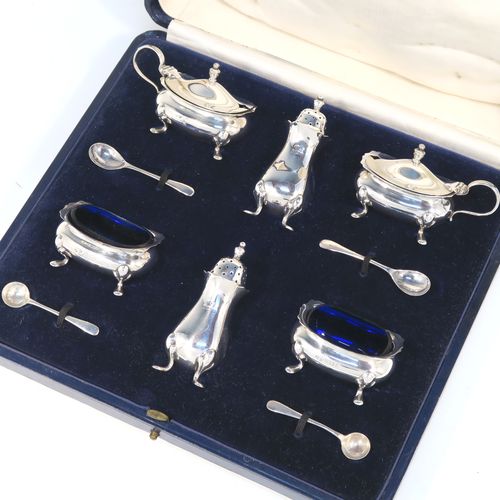 A handsome Antique Sterling Silver six-piece condiment service in the Chippendale style, consisting of two mustard pots with hinged lids and blue-glass liners, two salt cellars with blue-glass liners, two pepper pots with pull-off lids, all with bellied bodies and sitting on four scroll feet, together with two salt spoons and two mustard spoons, and all fitted into their original cream satin and and dark blue velvet-lined presentation box. This beautiful antique silver condiment service was made by Suckling Ltd., of Sheffield in 1923/4. The dimensions of this fine hand-made antique condiment service are height of pepper pots 7.5 cms (3 inches), length of mustard pots 7.5 cms (3 inches), and length of salt cellars 6 cms (2.3 inches), and with a total weight of approx. 208g (6.7 toy ounces).