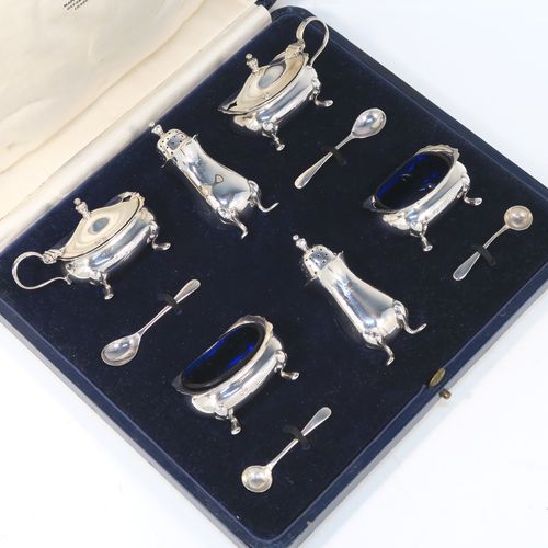 A handsome Antique Sterling Silver six-piece condiment service in the Chippendale style, consisting of two mustard pots with hinged lids and blue-glass liners, two salt cellars with blue-glass liners, two pepper pots with pull-off lids, all with bellied bodies and sitting on four scroll feet, together with two salt spoons and two mustard spoons, and all fitted into their original cream satin and and dark blue velvet-lined presentation box. This beautiful antique silver condiment service was made by Suckling Ltd., of Sheffield in 1923/4. The dimensions of this fine hand-made antique condiment service are height of pepper pots 7.5 cms (3 inches), length of mustard pots 7.5 cms (3 inches), and length of salt cellars 6 cms (2.3 inches), and with a total weight of approx. 208g (6.7 toy ounces).