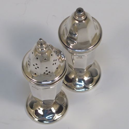 A handsome pair of Sterling Silver salt and pepper shakers, in a panelled Art Deco style, with pull-off lids and sitting on pedestal feet. These elegant silver salt and pepper pots were made by Emile Viner of Sheffield in 1938. The dimensions of this fine hand-made pair of silver pepper and salt shaker pots are height 10 cms (4 inches), diameter of main bodies 3.5 cms (1.3 inches), and the total weight is approx. 94g (3 troy ounces).  
