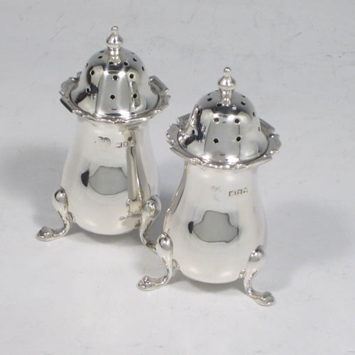 Antique sterling silver eight-piece condiment set, consisting of four open salt cellars with blue-glass liners, two mustard pots with hinged lids, and two pepper shakers, all with plain baluster round bodies, chippendale borders, and sitting on four cabriole legs, and all fitted into an original satin and velvet-lined presentation box. Made by Robert and William Sorely pf London in 1911. The dimensions of this fine hand-made silver condiment service are height of pepper pots 7 cms (2.75 inches), length of mustard pots 7 cms (2.75 inches), and with a total weight of approx. 252g (8 troy ounces). 
