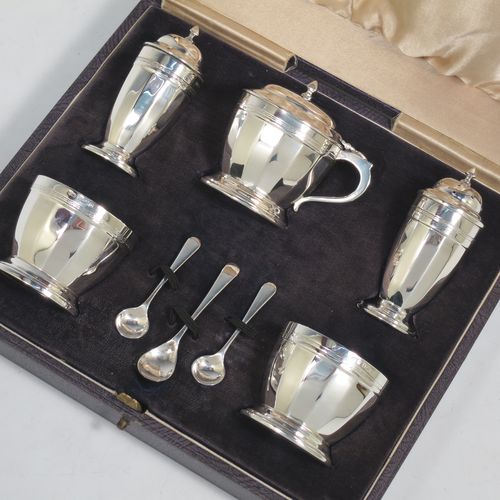 A very stylish Sterling Silver Art Deco five-piece condiment service in a plain round panelled style, consisting of a covered mustard pot with blue-glass liner, two open salts with blue-glass liners, two pepper shakers with pull-off lids, and three condiment spoons, all in their cream satin & black velvet-lined presentation box. Made by Deakin and Francis of Birmingham in 1928. The dimensions of this fine hand-made silver condiment service are height of peppers 8 cms (3.25 inches), length of mustard pot 7 cms (2.75 inches), with a total weight of approx. 281g (9 troy ounces).